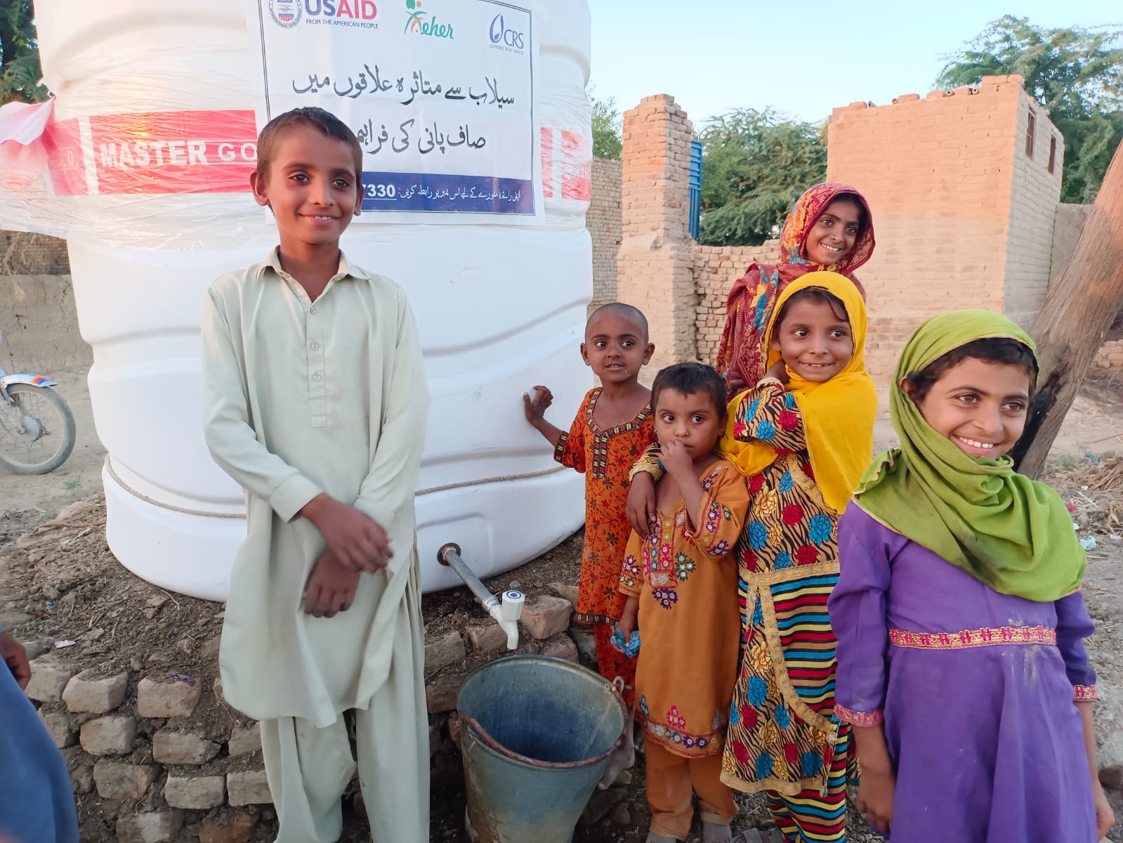 Children at a MEHER-installed clean water point in Jaffarabad